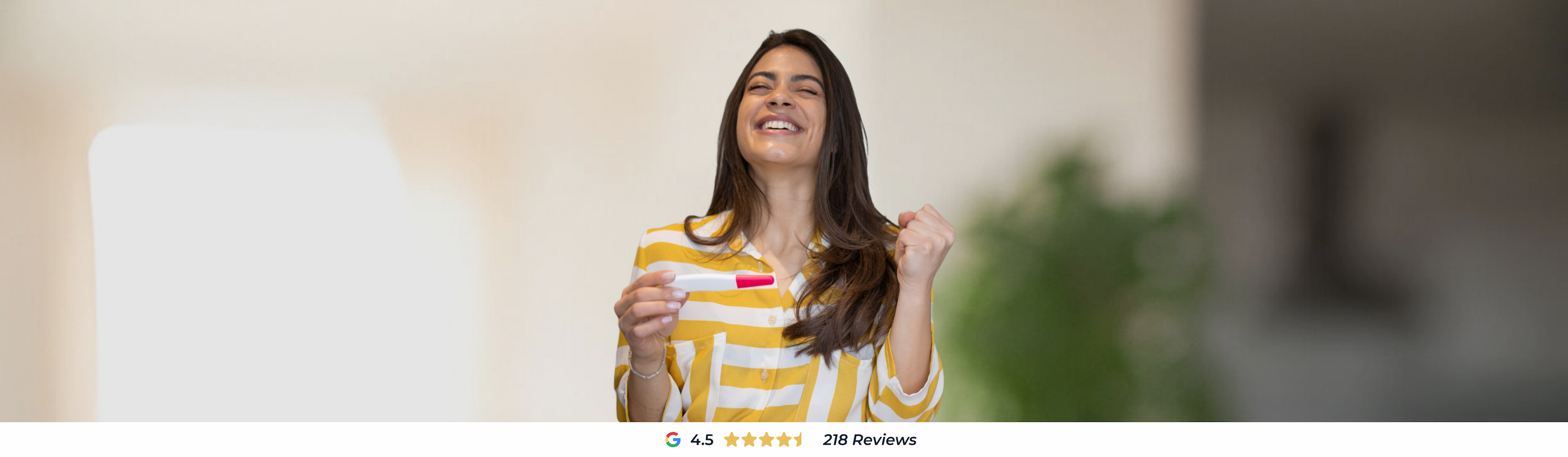 Woman celebrating positive pregnancy test