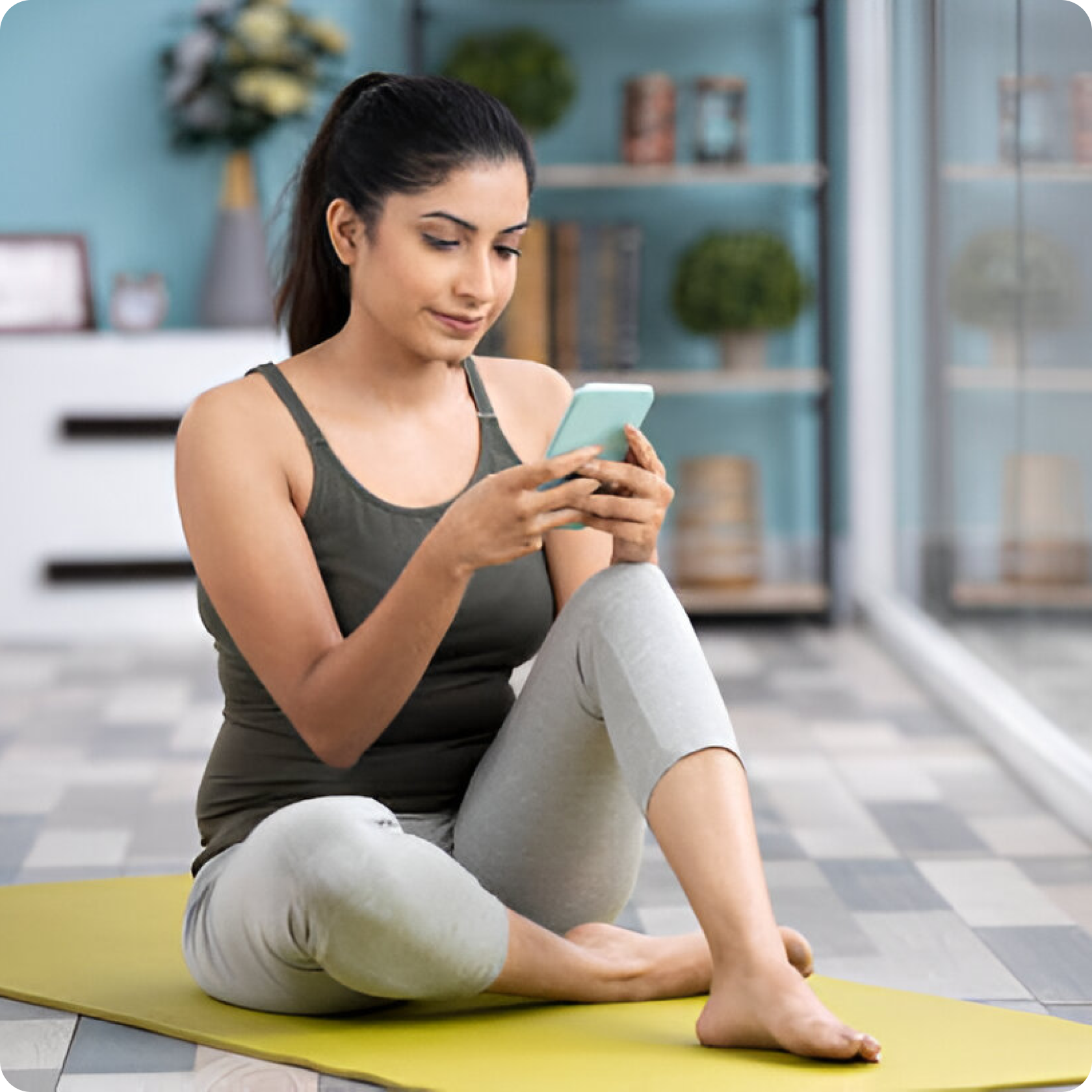 Woman doing yoga and checking phone